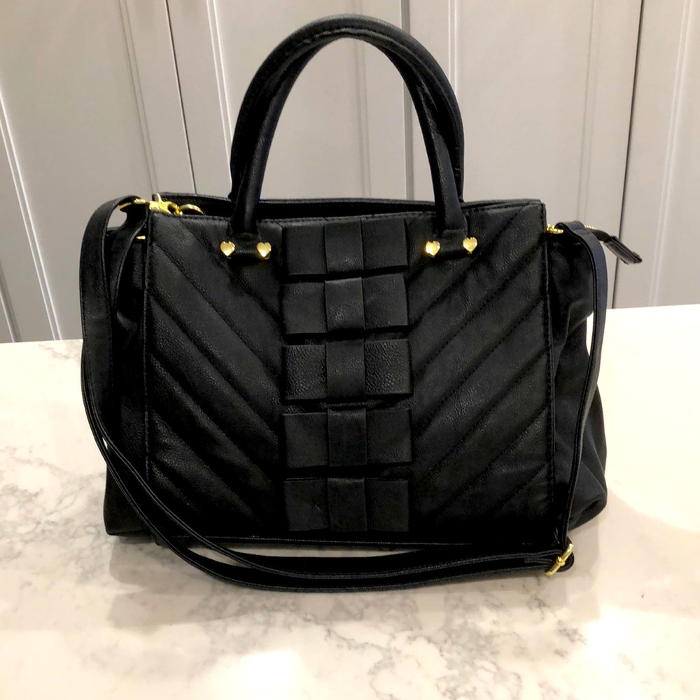 Betsy Johnson midsized black leather handbag with bow front and shoulder strap